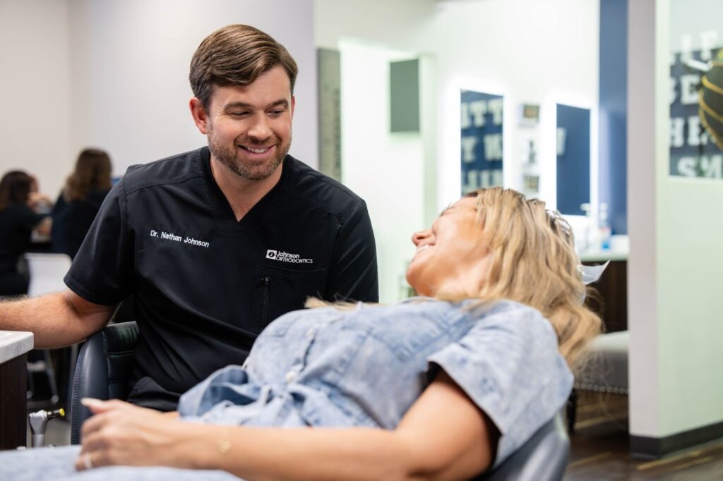 Dr. Nathan Johnson consulting with a patient in a modern orthodontic office, showcasing personalized care and a friendly atmosphere.